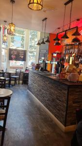 a bar in a restaurant with a brick wall at The New Alexandra Hotel in Llandudno