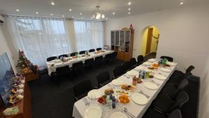 a conference room with long tables and black chairs at Sanatoriy Samara in Samarske Village