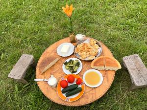 a picnic table with a plate of food and bread at Lake shkodra in Omarë