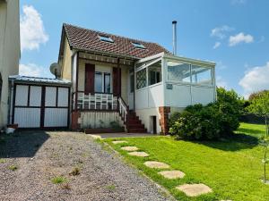 a house with a pathway in front of it at Maison vue mer 4 personnes in Arromanches-les-Bains