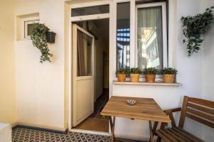 a wooden table next to a window with potted plants at Elite Marmara Express Otel in Istanbul