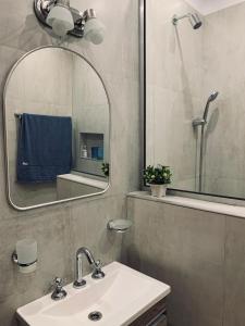 a bathroom with a sink and a mirror at Casa Norte in Concordia +39 photos