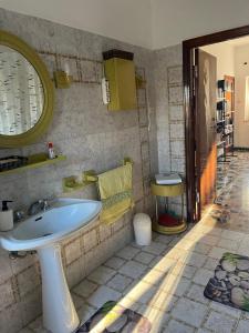 a bathroom with a sink and a mirror at B&B Locanda Pinà - Room 1 in Montemarciano