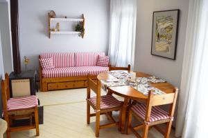 a living room with a table and a couch at Nicola's House with private parking in Kavála