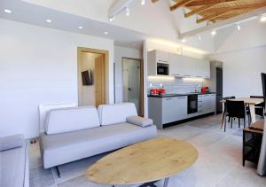 a living room with a couch and a wooden table at Demar Suites Vlycho Lefkada in Vlikhón