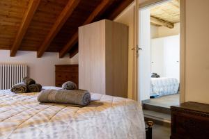 a bedroom with a bed with two pillows on it at Casa Sina -la villetta nel borgo in Massino Visconti