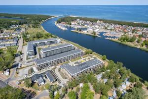 an aerial view of a building next to a river at Eleganckie Studio Basen, Fitness & Balkon by Noclegi Renters in Dziwnów