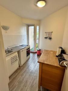 une cuisine avec un comptoir en bois dans une pièce dans l'établissement Appartement 58m2 lumineux en face du Parc des expositions, à Vanves 3 autres photos