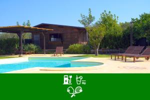 a picture of a pool with benches and a house at Agriturismo Mammarella in Altavilla Silentina