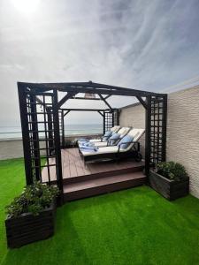 a gazebo with two beds on a green lawn at Atico LUXURY Magic World in Oropesa del Mar +19 photos