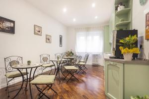 a kitchen with tables and chairs in a room at Le Scalette Al Vaticano B&B in Rome