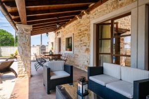 a patio with two couches and a table and chairs at VILLA GINA in Valtura