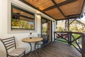 a patio with a table and chairs on a deck at Novelle Vista Cottage in Hout Bay