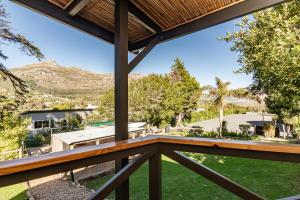 a view of the backyard from the deck of a house at Novelle Vista Cottage in Hout Bay