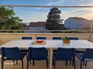 a table and chairs on a balcony with a view at Otto Novalja, spacious penthouse apartment in city center in Novalja
