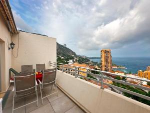 a balcony with chairs and a view of the ocean at Monaco Dream Seaview, Bnbrickeys in Beausoleil