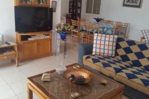 a living room with a couch and a table at 3-Bedroom House Near the Beach in Paralimni