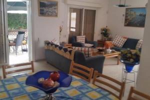 a living room with a couch and a table at 3-Bedroom House Near the Beach in Paralimni