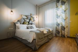 a bedroom with a large bed and a window at TORTE & LINI in Bologna