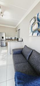a living room with a couch and a kitchen at 180 on Emmet in Vryheid