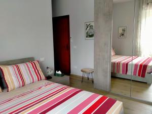 a bedroom with two beds and a mirror at SERENDIPITY B&b in Fabriano