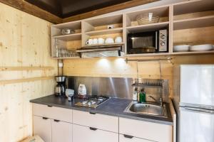a kitchen with a sink and a microwave at Citykamp d'Aix-en-Provence in Aix-en-Provence