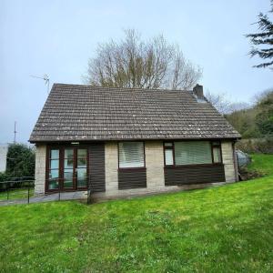 a small house on a hill with a green yard at South Sands Hotel in Weston-super-Mare