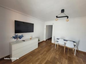 a living room with a tv and a table and chairs at Bella Vista 2 in Piles