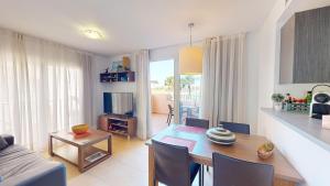 a living room with a table and a dining room at Casa Espliego GM-Murcia Holiday Rentals Property in Los Martínez