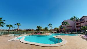 a swimming pool at a resort with palm trees at Casa Espliego GM-Murcia Holiday Rentals Property in Los Martínez