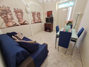 a living room with a blue couch and a table at Sicilia Mount&Sea in Mascali
