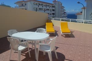 a white table and chairs on a balcony at Arena Sol in Puerto de Santiago