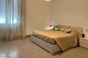 a bedroom with a bed with two pillows on it at Casa Il Gelso in Cattolica