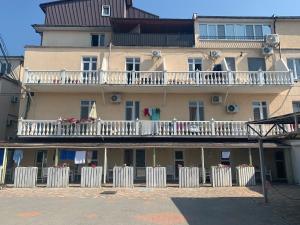 a large building with white balconies and white fences at SV apartments in Zatoka