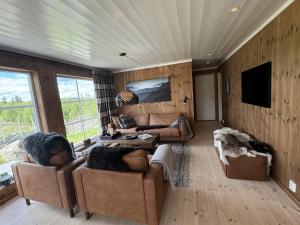 a living room with two couches and a tv at New and cozy family cabin on Golsfjellet in Golsfjellet