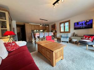 a living room with a couch and a table at Duplex spacieux proche des remontées, balcon, animaux admis, WIFI - FR-1-624-13 in Samoëns