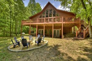 a house with rocking chairs in front of it at Anchors Away - Lake Nottely - Blairsville GA - Hot Tub, Private Dock, Fire Pits, and Stunning Lake Views at Lake Nottely in Mashburn Mill