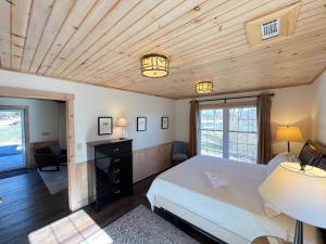 a bedroom with a white bed and a wooden ceiling at Blue Ridge Lake Retreat - Lakefront Luxury Home - Private Dock, Hot Tub, Sundeck, Private Boat Launch, Near Downtown - Blue Ridg in Blue Ridge