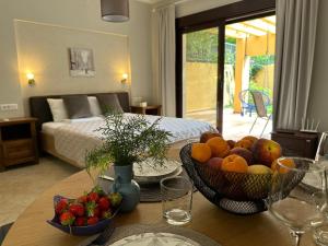 a room with a table with a bowl of fruit at Villa Risan Apartments in Risan