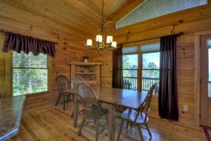 a dining room with a wooden table and chairs at Eagles View - Full Mountain View Pet Friendly in Blue Ridge