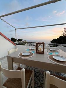 a table on a balcony with a view of the ocean at Cataleya Praia a Mare in Praia a Mare
