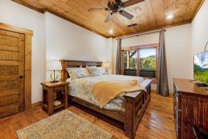 a bedroom with a bed and a wooden ceiling at Copperline Lodge - Luxury Creekside Retreat - Creekside Views, Hot Tub, Game Room, Outdoor Fireplaces, Chef Kitchen, Fire Pit - in Epworth