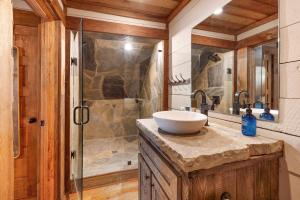 a bathroom with a sink and a shower at Copperline Lodge - Luxury Creekside Retreat - Creekside Views, Hot Tub, Game Room, Outdoor Fireplaces, Chef Kitchen, Fire Pit - in Epworth +65 photos