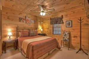 a bedroom with a bed and a ceiling fan at Falling Leaf - Mountain Views, Hot Tub, Game Room, Pet Friendly - Blue Ridge, GA in Blue Ridge