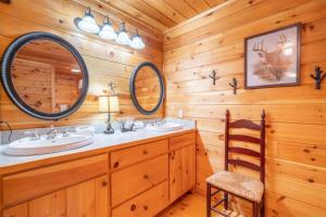 a bathroom with two sinks and two mirrors at Hibernation Station - Hot Tub, Fireplace, Serene Forest Views - Cherry Log, GA in Blue Ridge +22 photos