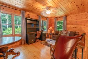 a log cabin office with a desk and a computer at Hibernation Station - Hot Tub, Fireplace, Serene Forest Views - Cherry Log, GA in Blue Ridge