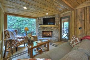 a living room with a couch and a fireplace at Hothouse Hideaway - Hothouse Creek - Toccoa River in Mineral Bluff