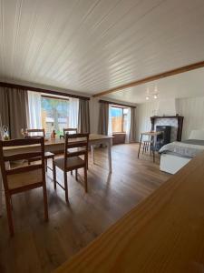 a living room with a bed and a table and chairs at Cozy 2-Bedroom Bungalow in Interlaken +37 photos