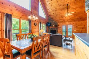 a dining room and living room with a table and chairs at Hawks Hideaway in Mineral Bluff