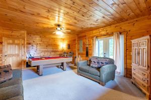 a living room with a pool table in a log cabin at Hawks Hideaway in Mineral Bluff +10 photos